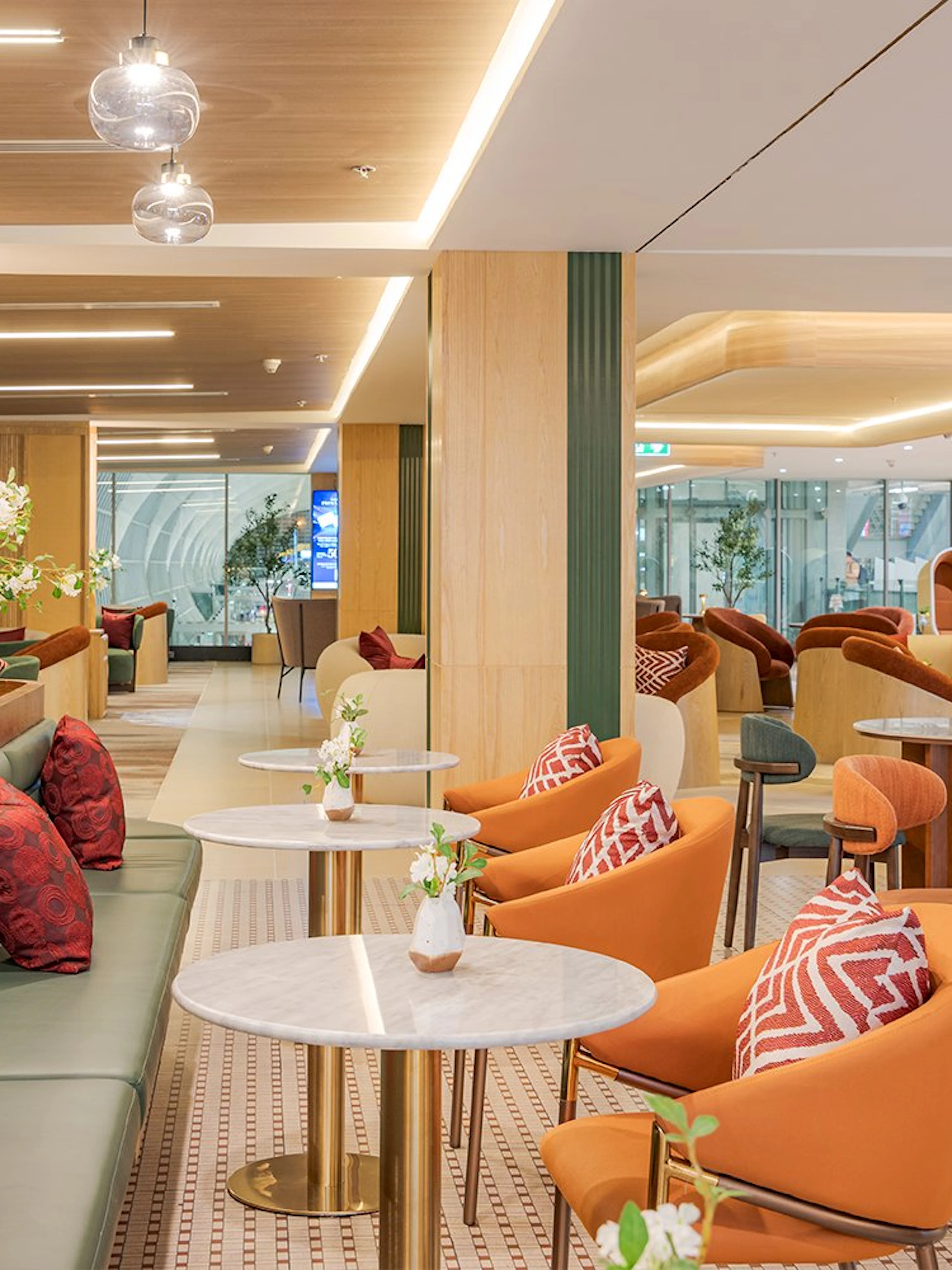 Coral Airport Lounge seating area at Suvarnabhumi Airport with modern decor.