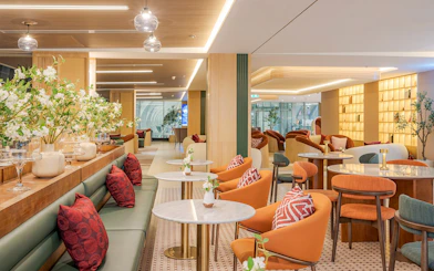 Coral Airport Lounge seating area at Suvarnabhumi Airport with modern decor.