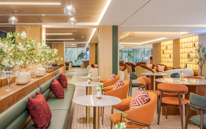 Coral Airport Lounge seating area at Suvarnabhumi Airport with modern decor.