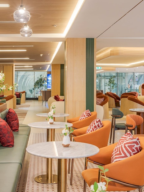 Coral Airport Lounge seating area at Suvarnabhumi Airport with modern decor.
