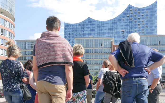 Group of tourists on a guided tour outside Elbphilharmonie, Hamburg.