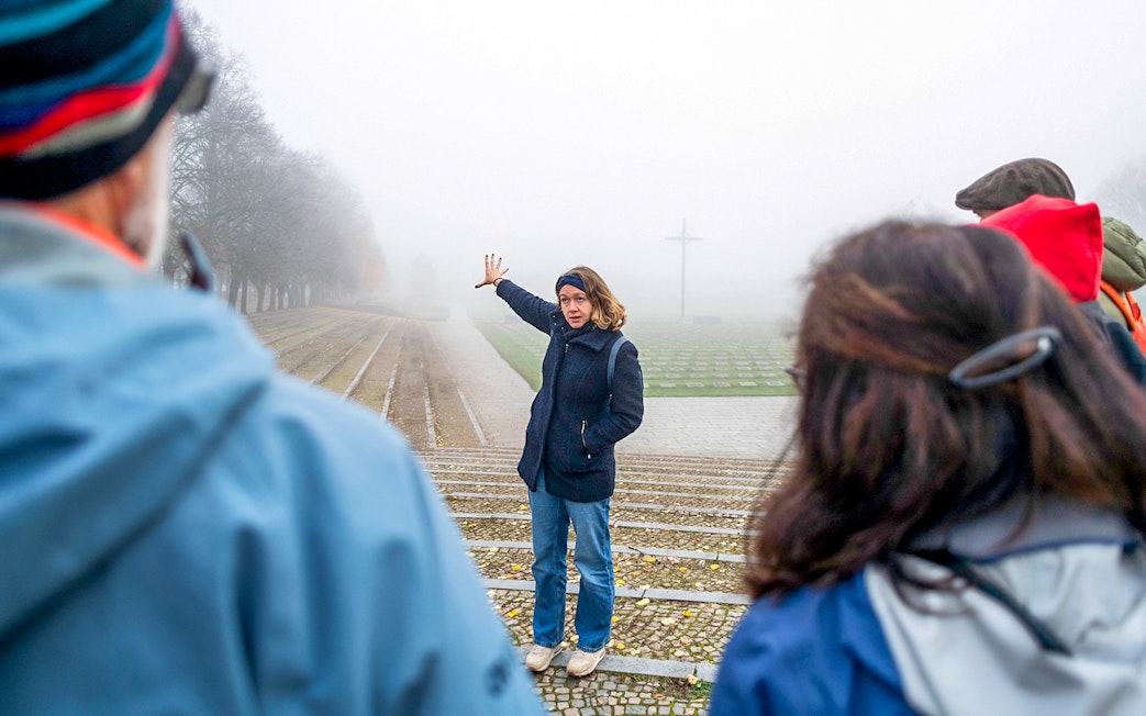 Guide explaining history to tourists at Terezin Concentration Camp.