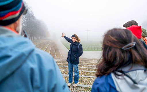 Guide explaining history to tourists at Terezin Concentration Camp.