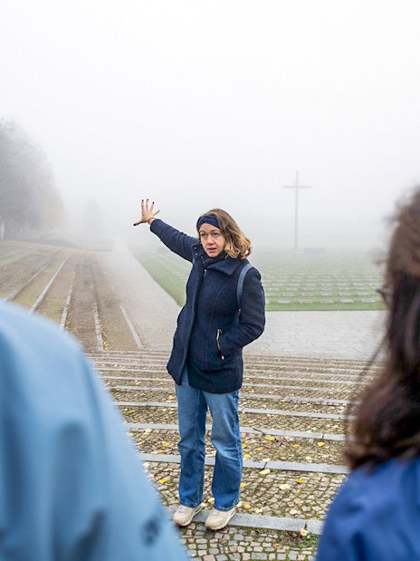 Guide explaining history to tourists at Terezin Concentration Camp.