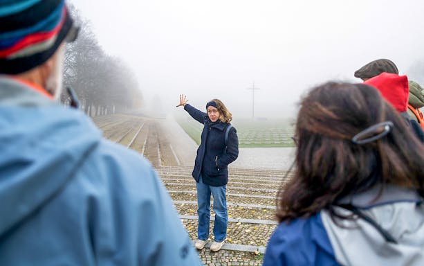 Guide explaining history to tourists at Terezin Concentration Camp.