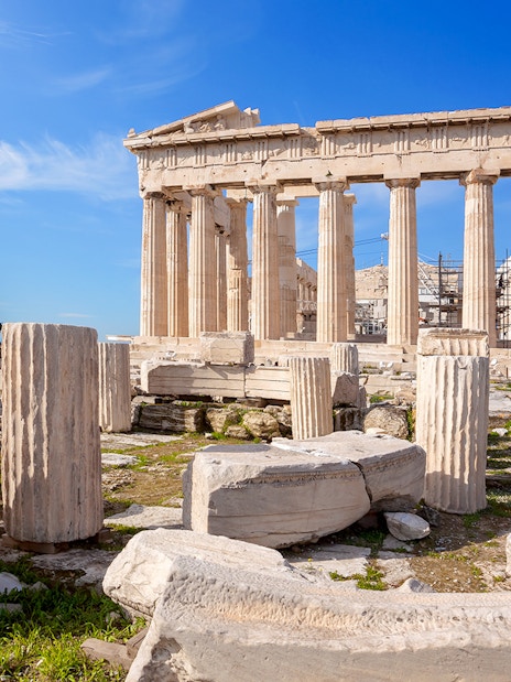 Parthenon temple ruins on the Acropolis in Athens, Greece, with scattered ancient columns.