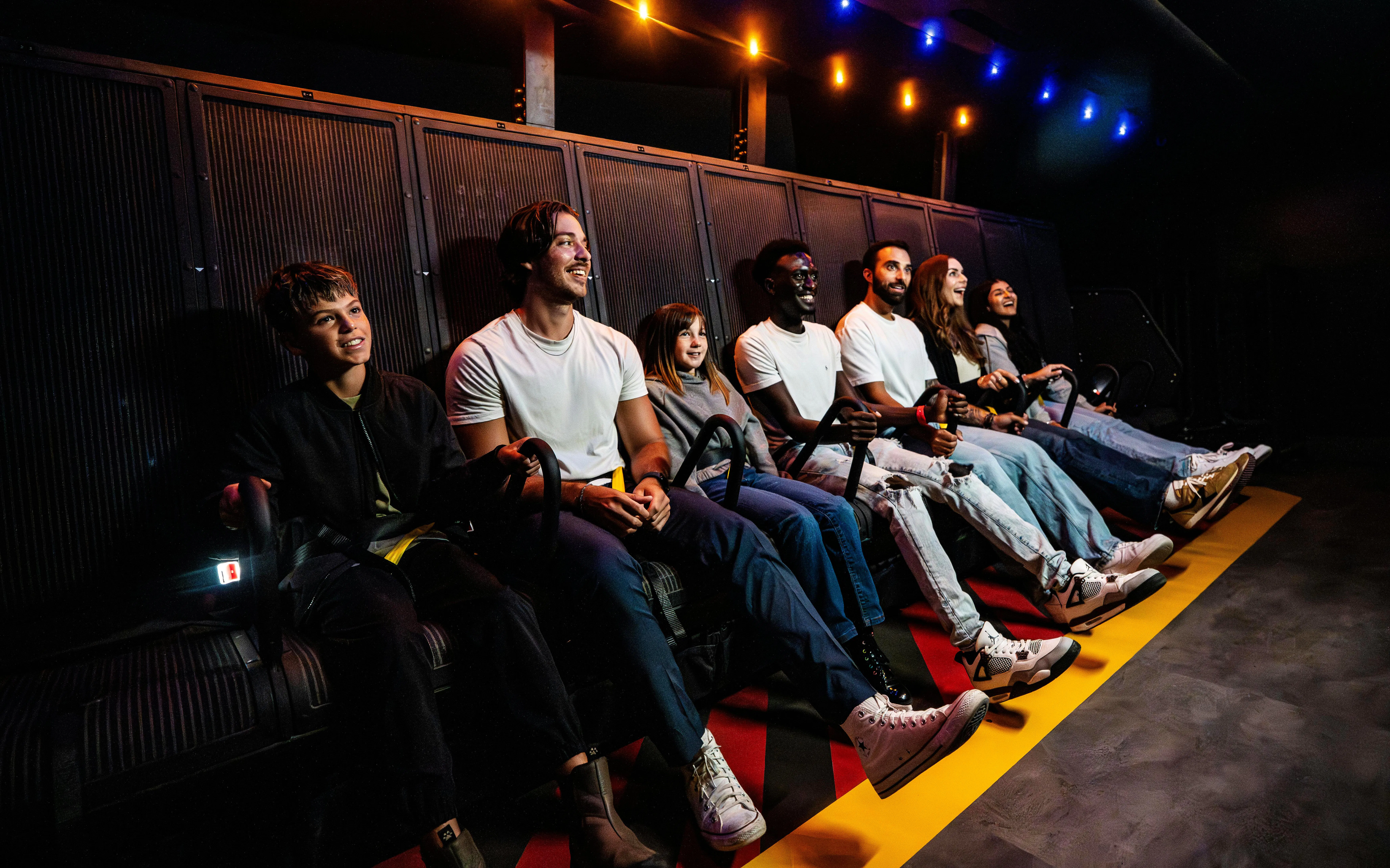Visitors enjoying a flight simulation ride at Niagara Takes Flight, Canada.