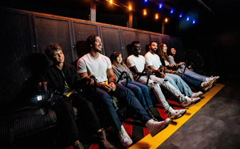 Visitors enjoying a flight simulation ride at Niagara Takes Flight, Canada.