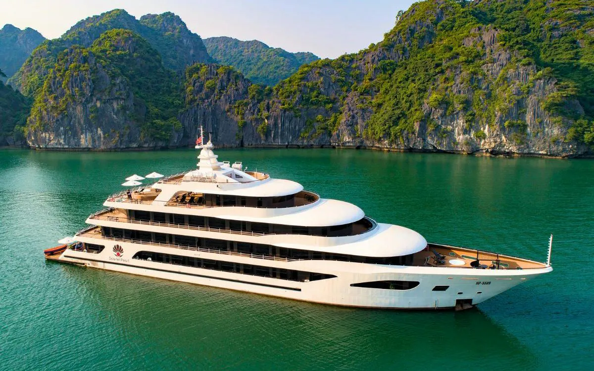Luxury cruise ship in Lan Ha Bay with limestone karsts in the background.