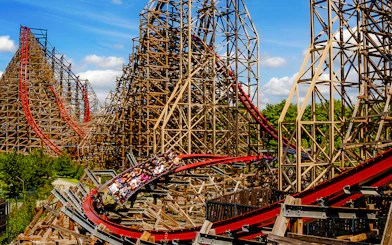 Rollercoaster at Energylandia Theme Park, Zator, Poland, with riders on a wooden track.