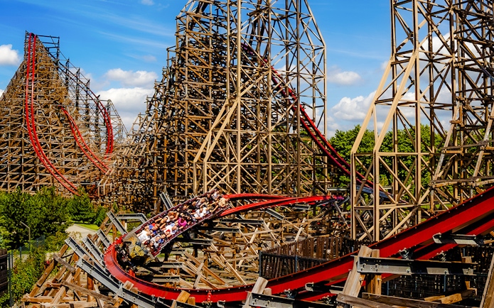 Rollercoaster at Energylandia Theme Park, Zator, Poland, with riders on a wooden track.