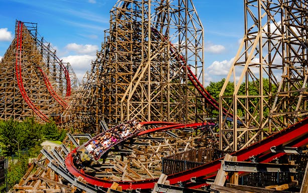 Rollercoaster at Energylandia Theme Park, Zator, Poland, with riders on a wooden track.