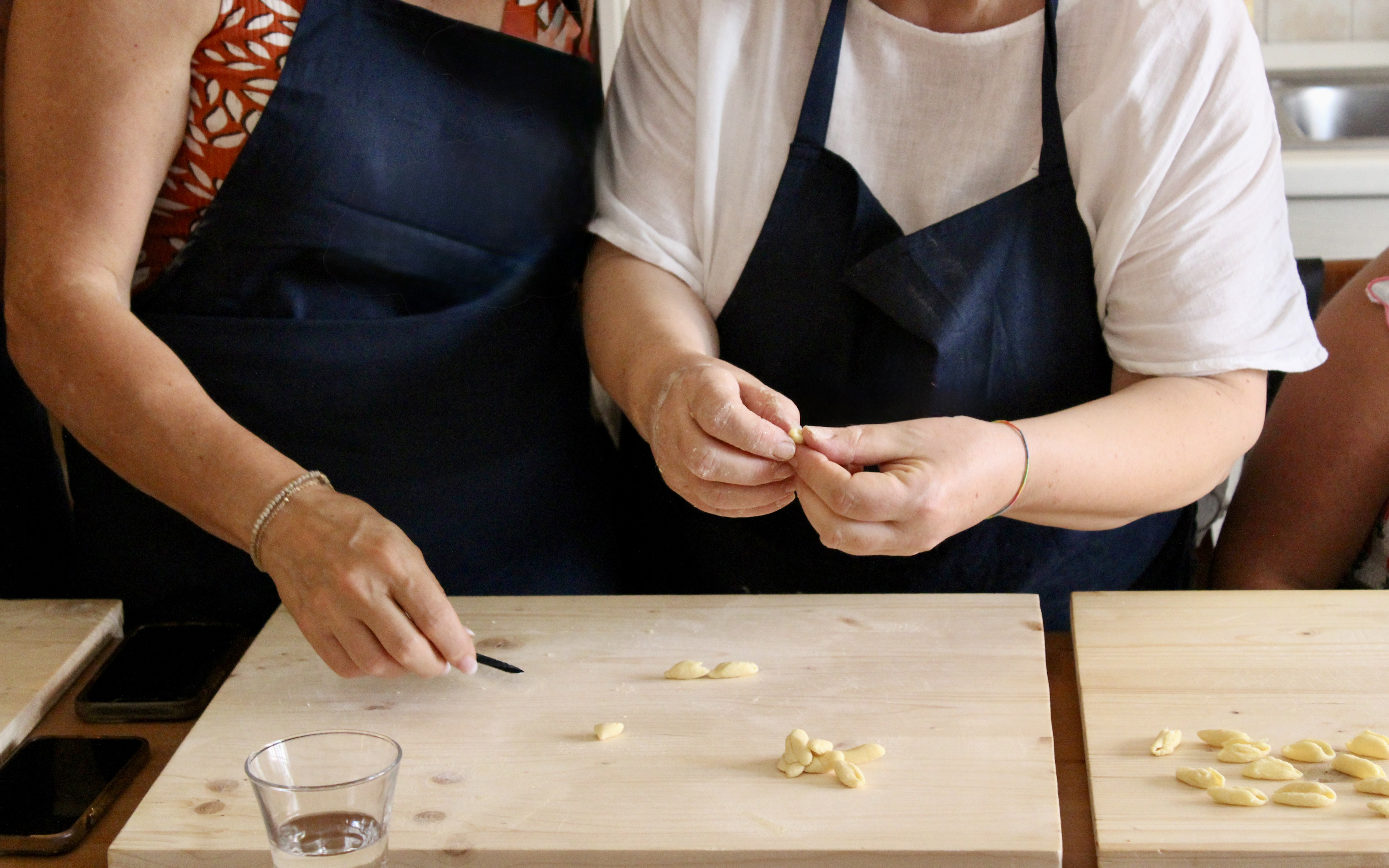 Participants shaping pasta at Polignano a Mare cooking class.