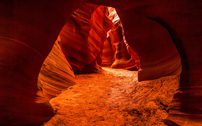 Rattlesnake Canyon sandstone formations with narrow passage and vibrant red hues.