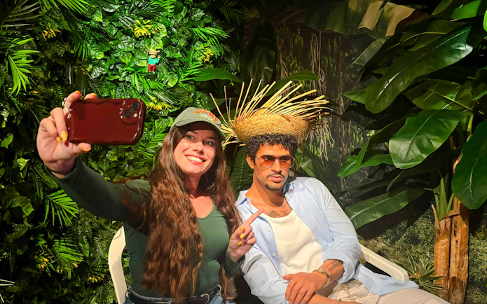 Visitor taking a selfie with a wax figure at Grévin Paris Wax Museum.