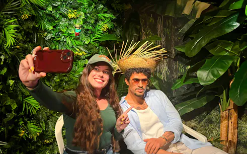 Visitor taking a selfie with a wax figure at Grévin Paris Wax Museum.