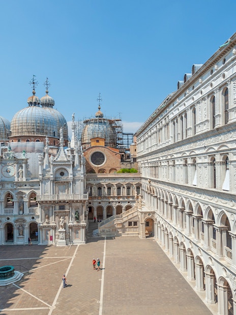 Doge's Palace courtyard with view of St. Mark's Basilica domes in Venice.