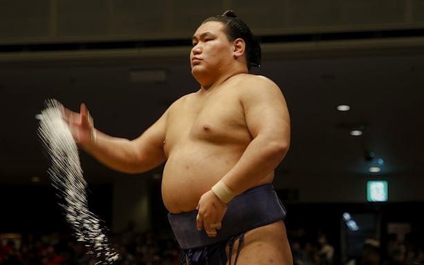 Sumo wrestler performing salt ceremony in Japan.