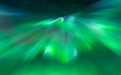 Northern Lights display in Tromsø sky during aurora chase tour.