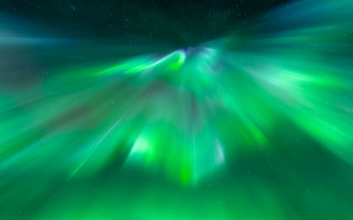 Northern Lights display in Tromsø sky during aurora chase tour.