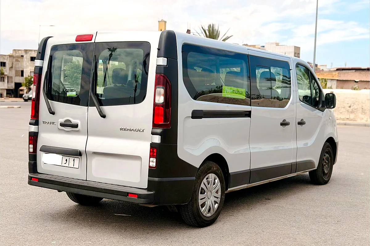 White van for airport transfers in Marrakech, parked in urban setting.