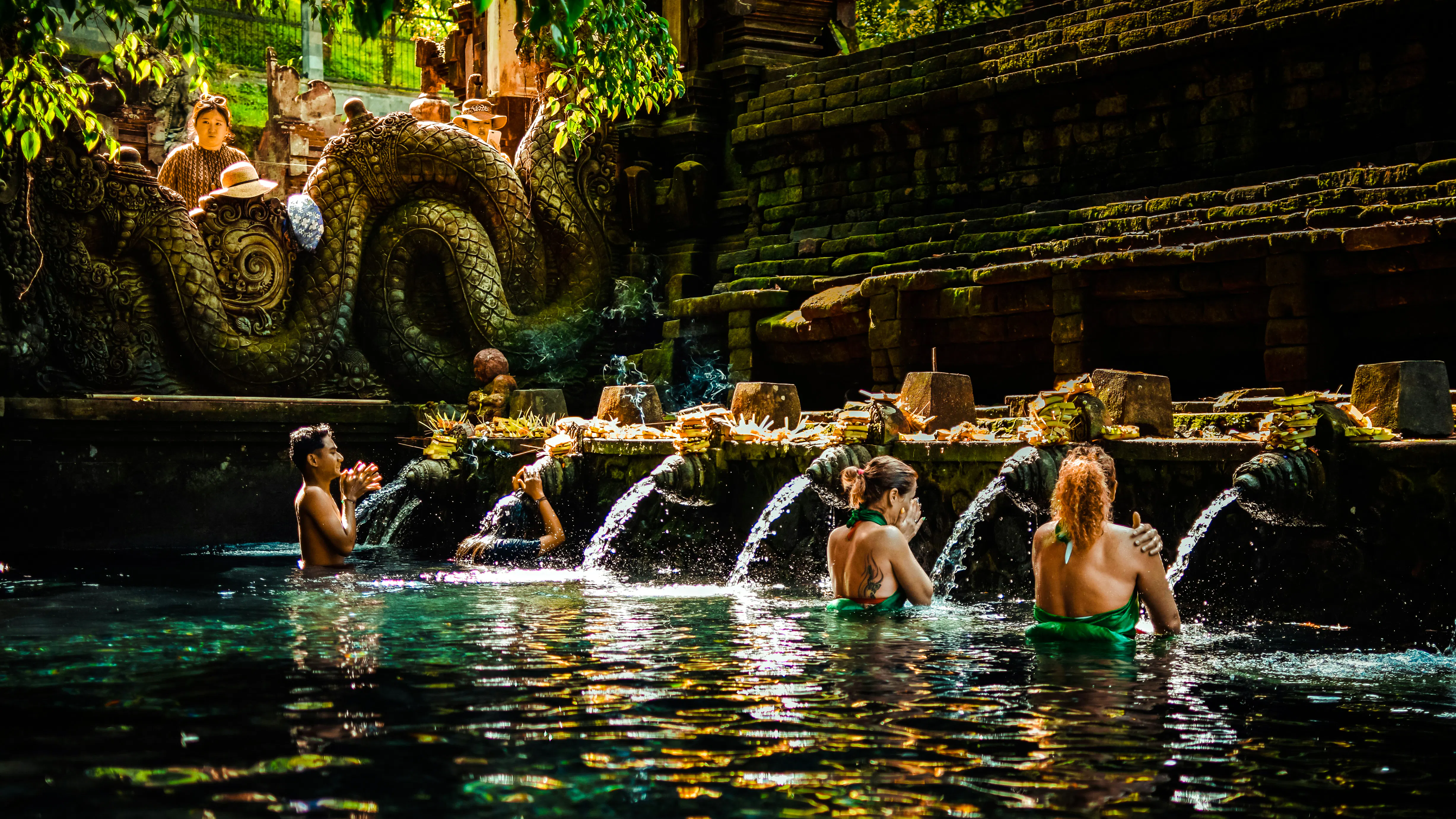Visitors participating in water purification ritual at Tirta Empul Temple, Bali.