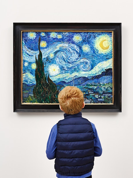 Child viewing Van Gogh's "Starry Night" painting in a museum.