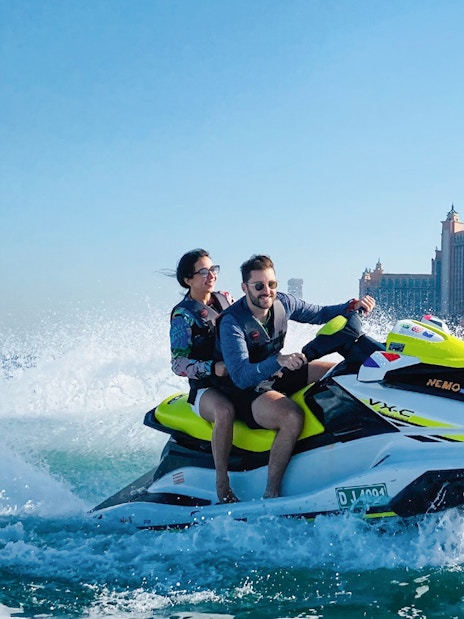Couple jet skiing near Atlantis, The Palm in Dubai.