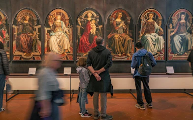 Visitors viewing Renaissance paintings at the Uffizi Gallery, Florence.