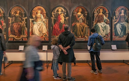 Visitors viewing Renaissance paintings at the Uffizi Gallery, Florence.