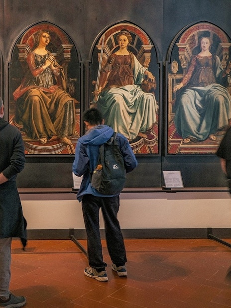 Visitors viewing Renaissance paintings at the Uffizi Gallery, Florence.