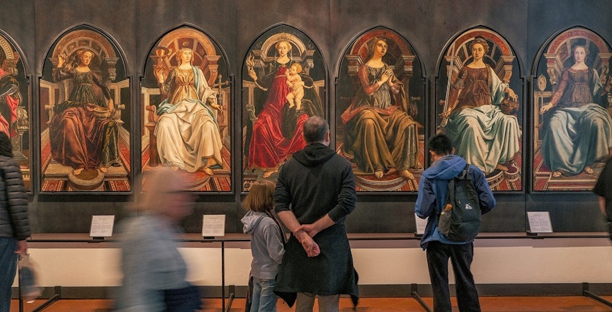 Uffizi Gallery courtyard with visitors in Florence, Italy.