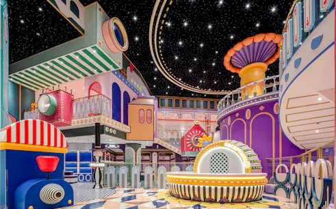 Colorful indoor play area with whimsical structures and starry ceiling in Bangkok old town.