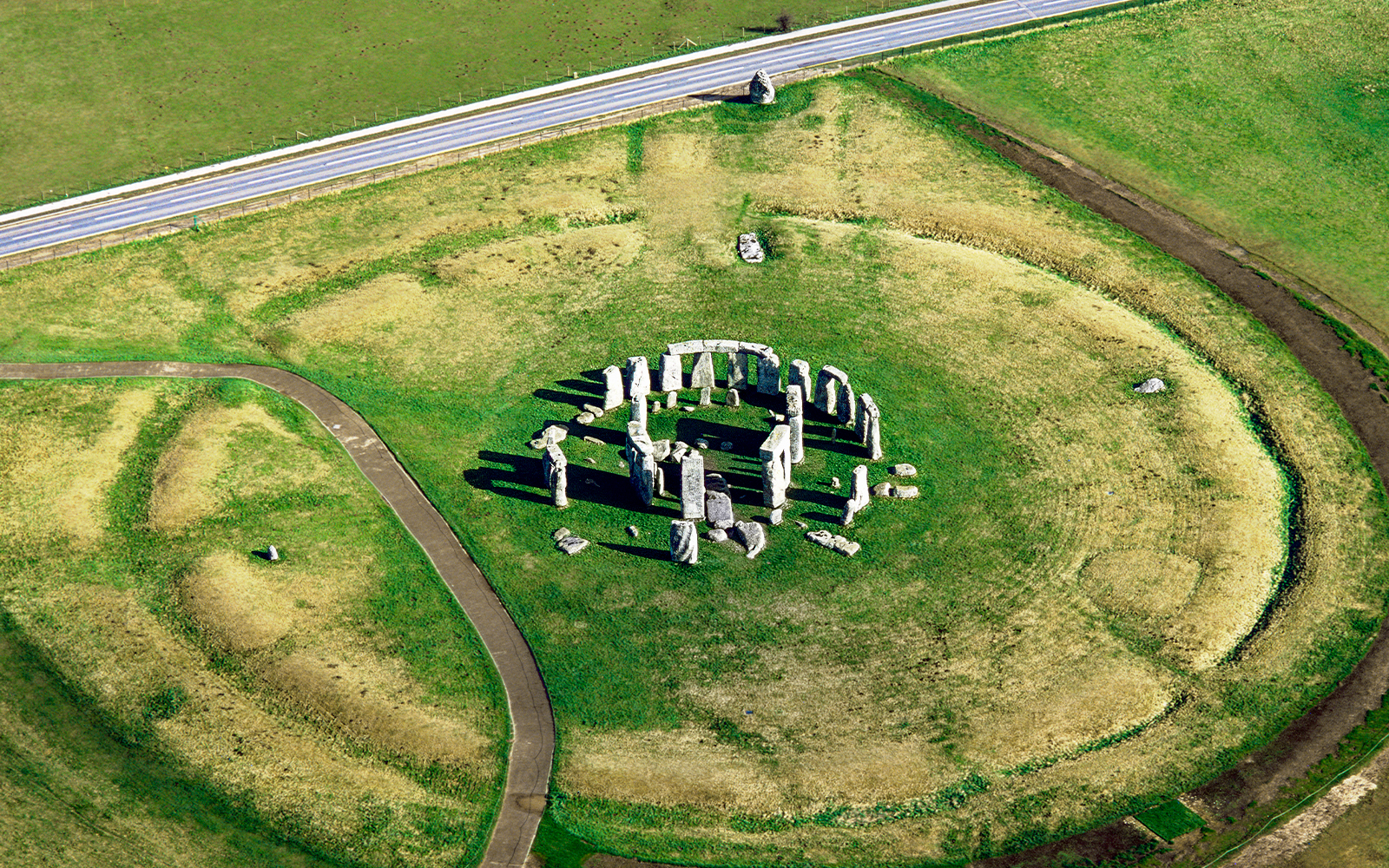 Stonehenge view from The Avenue, showcasing ancient stone circle in Wiltshire, England.