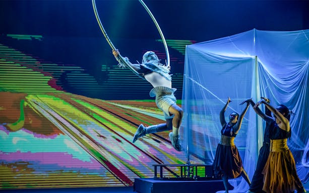 Performer in mid-air hoop act at Earth Symphony, Circus fest.