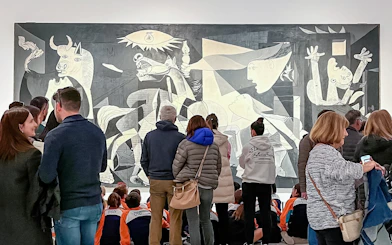 Visitors viewing Picasso's Guernica at Reina Sofia Museum, part of Paseo del Arte 3-Museum Pass.
