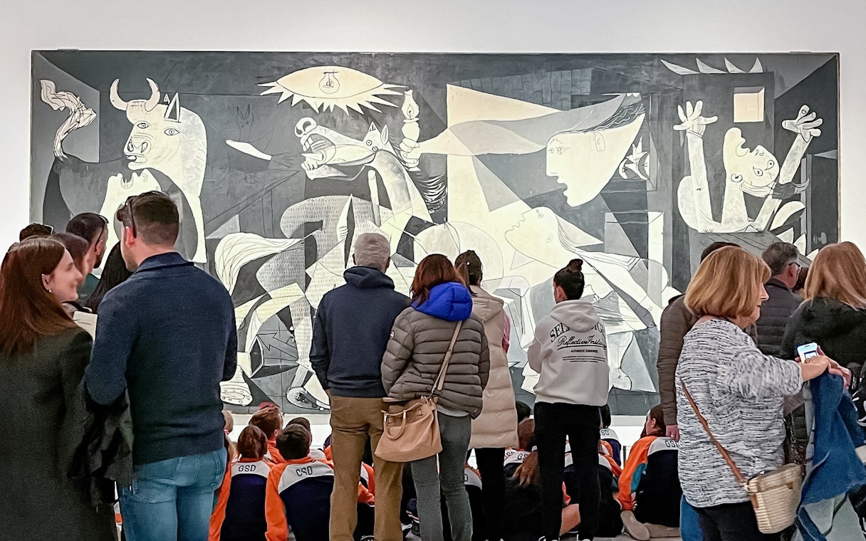 Visitors viewing Picasso's Guernica at Reina Sofia Museum, part of Paseo del Arte 3-Museum Pass.