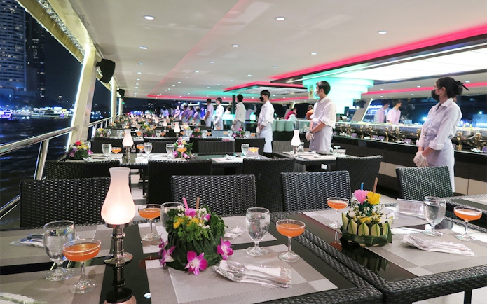 Dining setup on Chao Phraya Princess Cruise, Bangkok, with tables and staff.