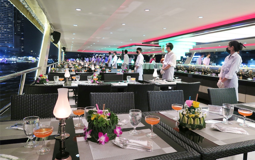 Dining setup on Chao Phraya Princess Cruise, Bangkok, with tables and staff.