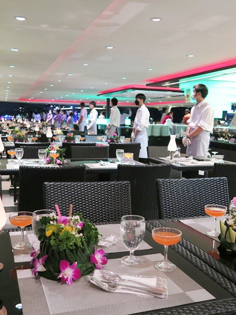 Dining setup on Chao Phraya Princess Cruise, Bangkok, with tables and staff.