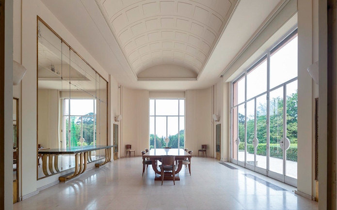Interior of Serralves Museum with large windows and elegant furniture in Porto, Portugal.