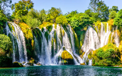 Kravica Waterfall cascading over lush greenery on Trebizat River, Bosnia.