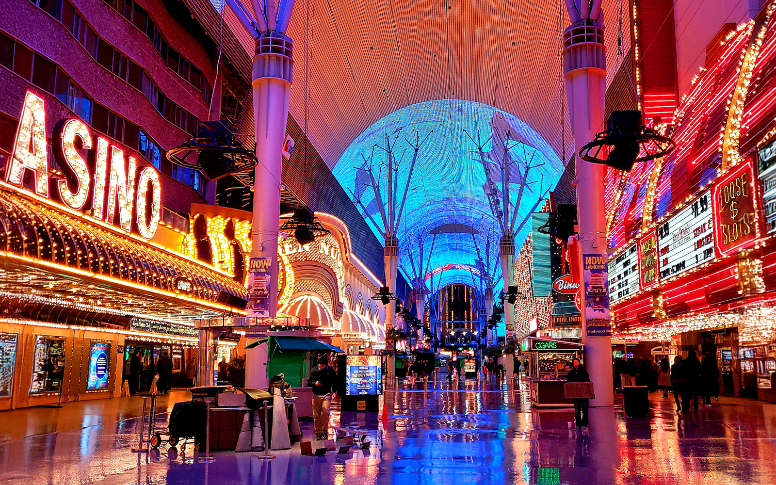 Fremont Street in Las Vegas with vibrant neon lights and casino signs.