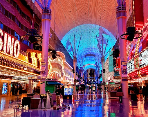 Fremont Street in Las Vegas with vibrant neon lights and casino signs.