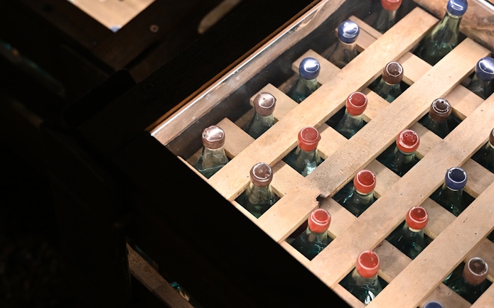 Vodka bottles in wooden crates at Krakow Vodka Factory Museum.