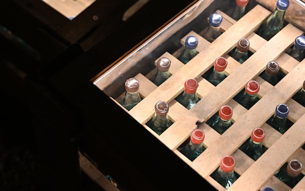 Vodka bottles in wooden crates at Krakow Vodka Factory Museum.