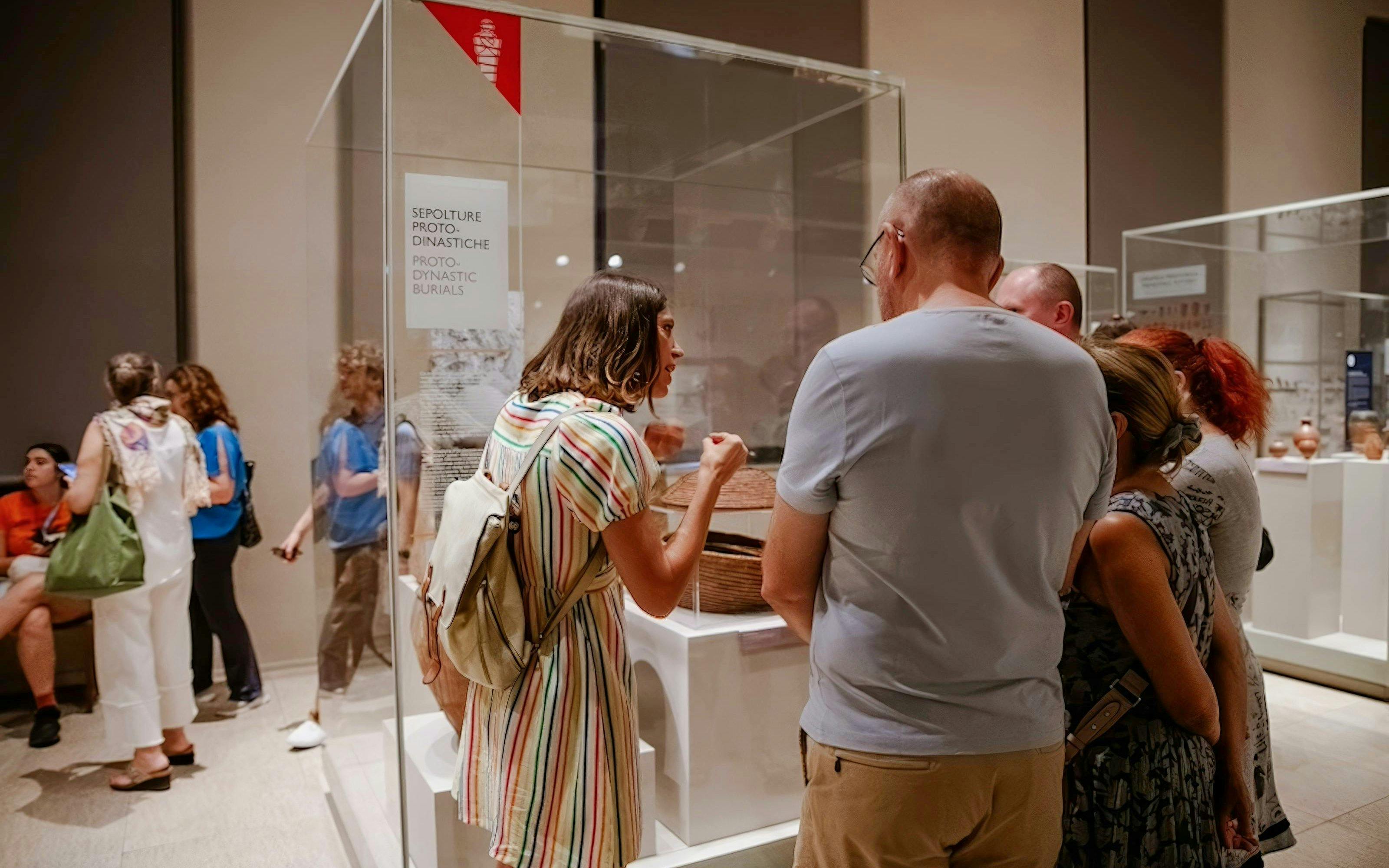 Visitors observing Proto-Dynastic burials exhibit at the Egyptian Museum in Turin.