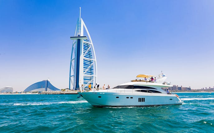 Luxury yacht near Burj Al Arab, Dubai, during a tour with live BBQ and drinks.