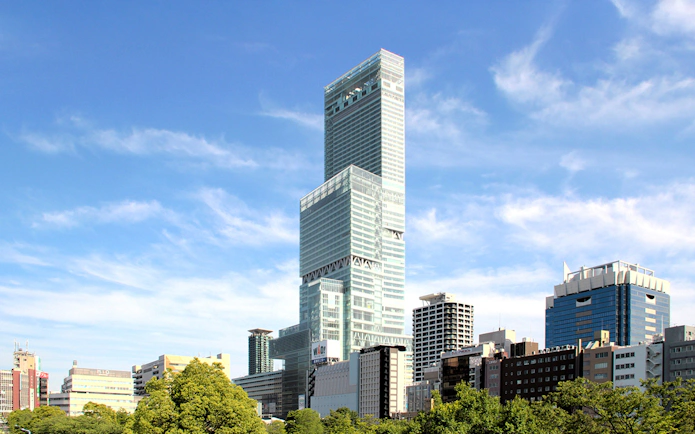 HARUKAS 300 skyscraper in Osaka, Japan, with cityscape and blue sky.
