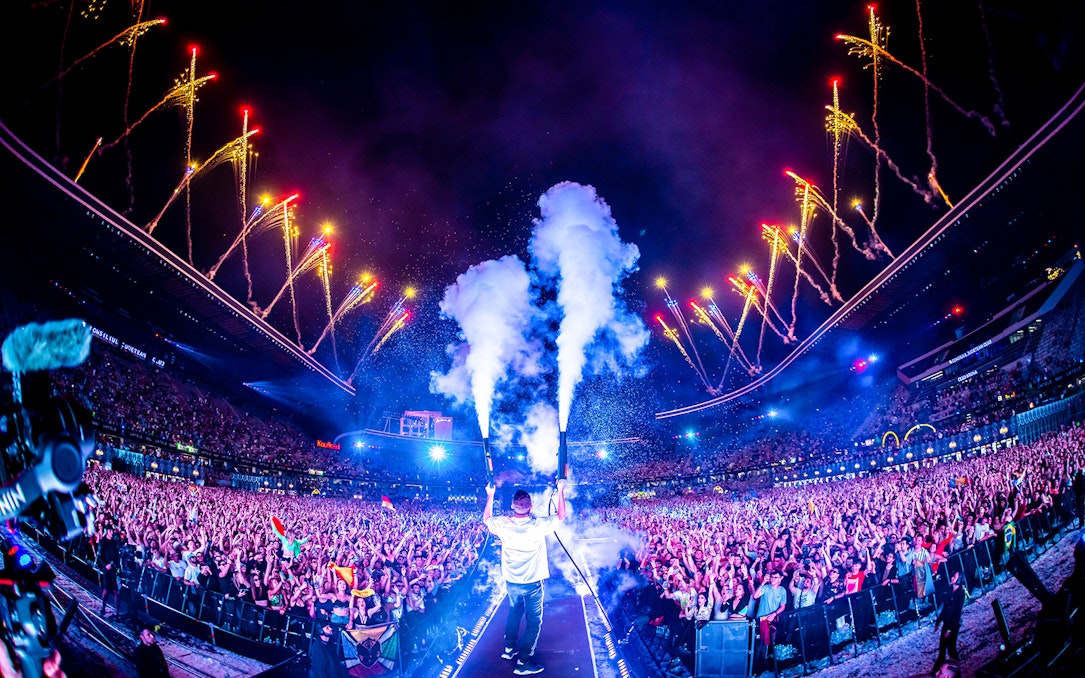 Crowd enjoying UNTOLD Music Festival Dubai with fireworks and stage effects.